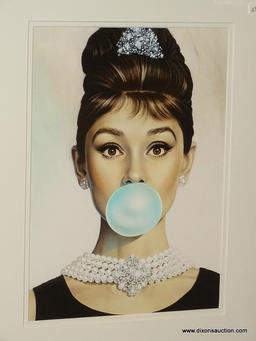 AUDREY HEPBURN FRAMED PHOTOGRAPH; SHOWS AUDREY HEPBURN BLOWING A BRIGHT BLUE BUBBLE. DOUBLE MATTED