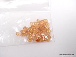 PARCEL BAG WITH 10CT OF MIXED, ROUND SPESSARTITE GARNETS. ROUGHLY 42 PIECES.