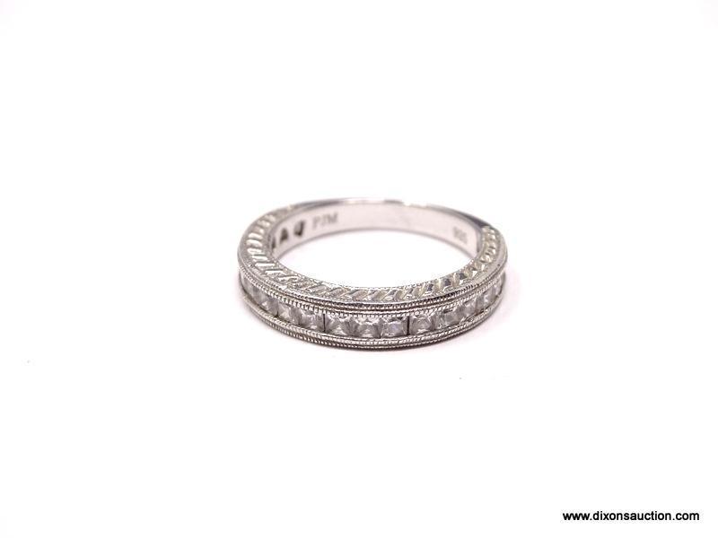 DIAMOND CHANNEL SET ETERNITY BAND. TOP 3/4 OF THE RING IS SET WITH 20 DIAMONDS. DESINGER SIGNED,