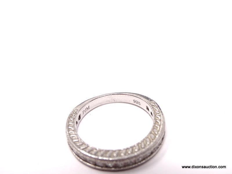 DIAMOND CHANNEL SET ETERNITY BAND. TOP 3/4 OF THE RING IS SET WITH 20 DIAMONDS. DESINGER SIGNED,