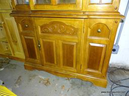 (GARAGE) CHINA CABINET; OAK 2 PC. CHINA CABINET- 1 CENTER CARVED AND GLASS DOOR WITH SIDELIGHTS, 2