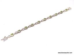 DAZZLING STERLING SILVER AND GEMSTONE BEZEL SET BRACELET. FEATURES A BOLD BOX CLASP WITH SAFETY SNAP