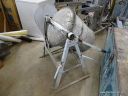 COMMERCIAL CONCRETE MIXER ON STAND. HEAVILY USED.