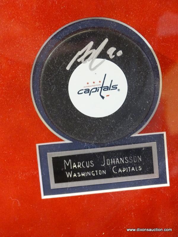 SIGNED WASHINGTON CAPITOLS LOGO PUCK; SIGNED BY MARCUS JOHANSSON. HAS COA IN A MANILLA ENVELOPE ON