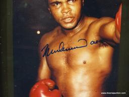 SIGNED MUHAMMAD ALI PHOTOGRAPH; IS OF AND SIGNED BY MUHAMMAD ALI WITH COA ON THE BACK FROM PRO