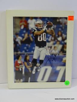 SIGNED NEW ENGLAND PATRIOTS PHOTOGRAPH; IS OF AND SIGNED BY DANNY AMENDOLA. IS IN A WHITE FRAME AND