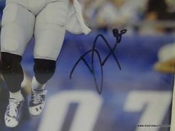 SIGNED NEW ENGLAND PATRIOTS PHOTOGRAPH; IS OF AND SIGNED BY DANNY AMENDOLA. IS IN A WHITE FRAME AND