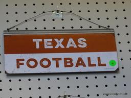 TEXAS FOOTBALL ADVERTISING SIGN; IS BROWN AND WHITE IN COLOR. MEASURES 12 IN X 5.5 IN