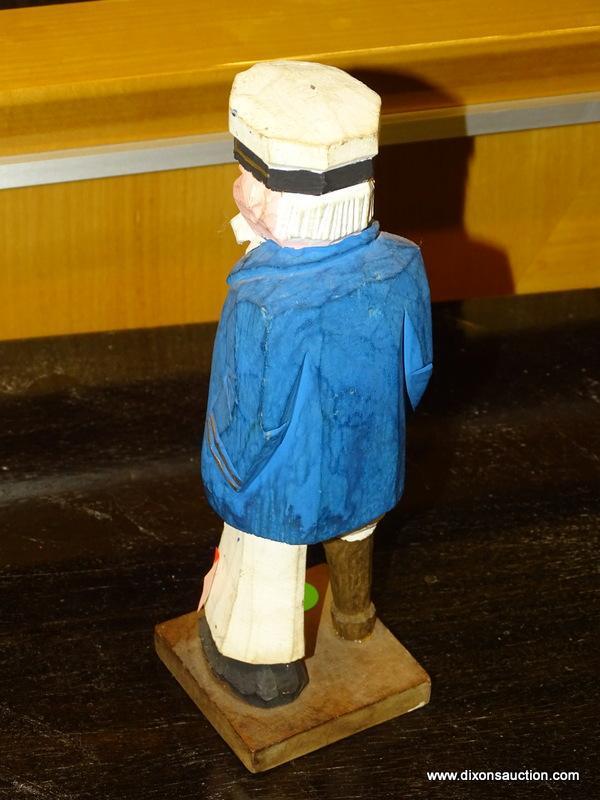 2 PIECE LOT; INCLUDES A WOODEN CARVED SEA CAPTAIN WITH A PEG LEG AND A LEFTON CHINA LIGHT HOUSE