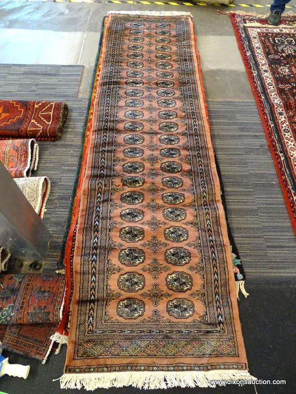 PAKISTAN BOKHARA RUG. MEASURES 2'8" X 9". SIGNED.