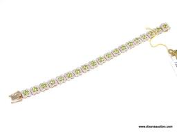 .925 SILVER PERIDOT & WHITE TOPAZ BRACELET WITH YELLOW GOLD OVERLAY. 19 SQUARE PERIDOT APPROX.
