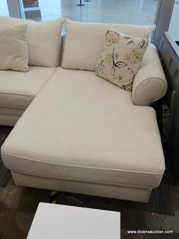 MODERN SECTIONAL SOFA WITH CREAM COLORED UPHOLSTERY AND MAHOGANY LEGS. MEASURES 142 IN X 108 IN X 36