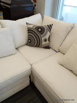 MODERN SECTIONAL SOFA WITH CREAM COLORED UPHOLSTERY AND MAHOGANY LEGS. MEASURES 142 IN X 108 IN X 36