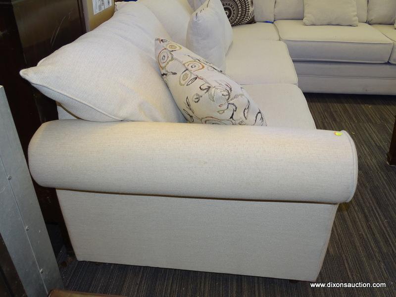 MODERN SECTIONAL SOFA WITH CREAM COLORED UPHOLSTERY AND MAHOGANY LEGS. MEASURES 142 IN X 108 IN X 36