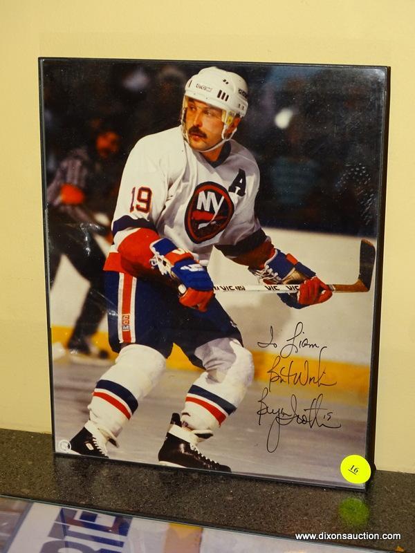 (BAS) FRAMED AND AUTOGRAPHED PHOTO OF BRYAN TROTTIER. IS IN A BLACK FRAME AND MEASURES 8.25 IN X