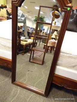 HIGHLY CARVED SOLID MAHOGANY FRAMED WALL MIRROR WITH BEVELED GLASS EDGE. MEASURES 26.5 IN X 63.5 IN.