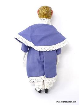 ANTIQUE PORCELAIN DOLL WITH A BLUE AND WHITE LACE DRESS. MEASURES APPROXIMATELY 8 IN TALL. ITEM IS