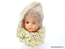 LOUIS NICHOLE PORCELAIN VICTORIAN DOLL HEAD MOUNTED ON LUCITE BASE. MEASURES 10.5 IN TALL. ITEM IS