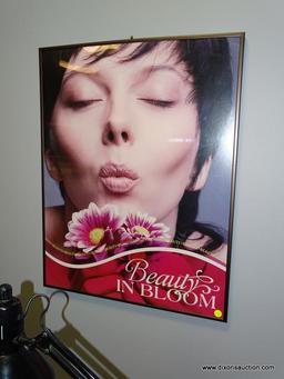 FRAMED ARTWORK "BEAUTY IN BLOOM". DEPICTS A GIRL MAKING A KISSING FACE WITH FLOWERS. MEASURES