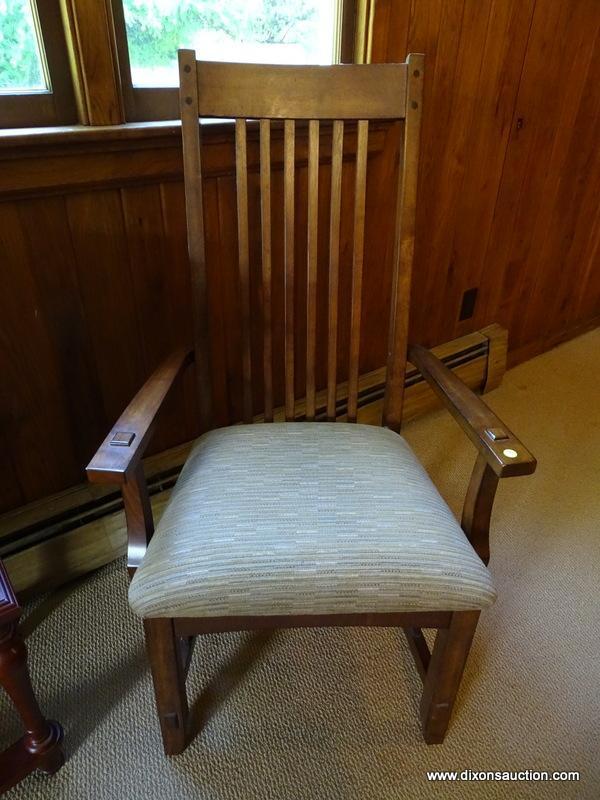 (DWN LR) SOLID OAK ARM CHAIR WITH BROWN AND TAN UPHOLSTERED SEAT WITH SLAT BACK. IS 1 OF A PAIR.