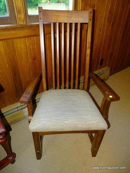 (DWN LR) SOLID OAK ARM CHAIR WITH BROWN AND TAN UPHOLSTERED SEAT WITH SLAT BACK. IS 1 OF A PAIR.