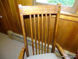 (DWN LR) SOLID OAK ARM CHAIR WITH BROWN AND TAN UPHOLSTERED SEAT WITH SLAT BACK. IS 1 OF A PAIR.