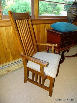 (DWN LR) SOLID OAK ARM CHAIR WITH BROWN AND TAN UPHOLSTERED SEAT WITH SLAT BACK. IS 1 OF A PAIR.