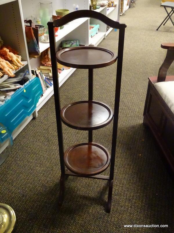 (R1) 3 TIER MAHOGANY FOLDING PIE STAND. MEASURES 12 IN X 11 IN X 40 IN. ITEM IS SOLD AS IS WHERE IS