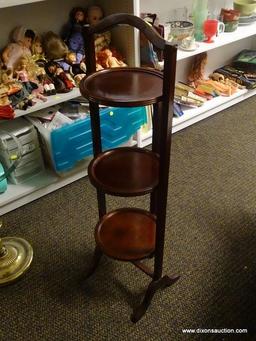 (R1) 3 TIER MAHOGANY FOLDING PIE STAND. MEASURES 12 IN X 11 IN X 40 IN. ITEM IS SOLD AS IS WHERE IS