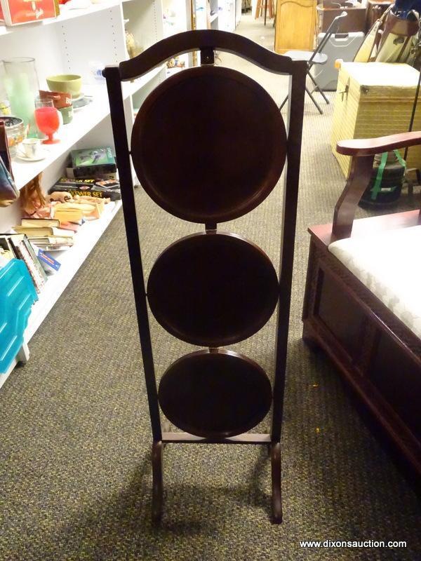 (R1) 3 TIER MAHOGANY FOLDING PIE STAND. MEASURES 12 IN X 11 IN X 40 IN. ITEM IS SOLD AS IS WHERE IS