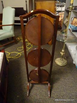 (R1) 3 TIER MAHOGANY FOLDING PIE STAND. MEASURES 12 IN X 11 IN X 40 IN. ITEM IS SOLD AS IS WHERE IS