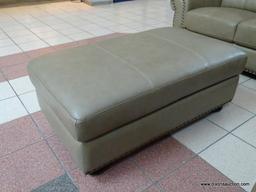 BRAND NEW TOP GRAIN LEATHER TAUPE OTTOMAN BY ABBYSON. HAS BRASS STUDDED ACCENTS ALONG THE EDGE AND