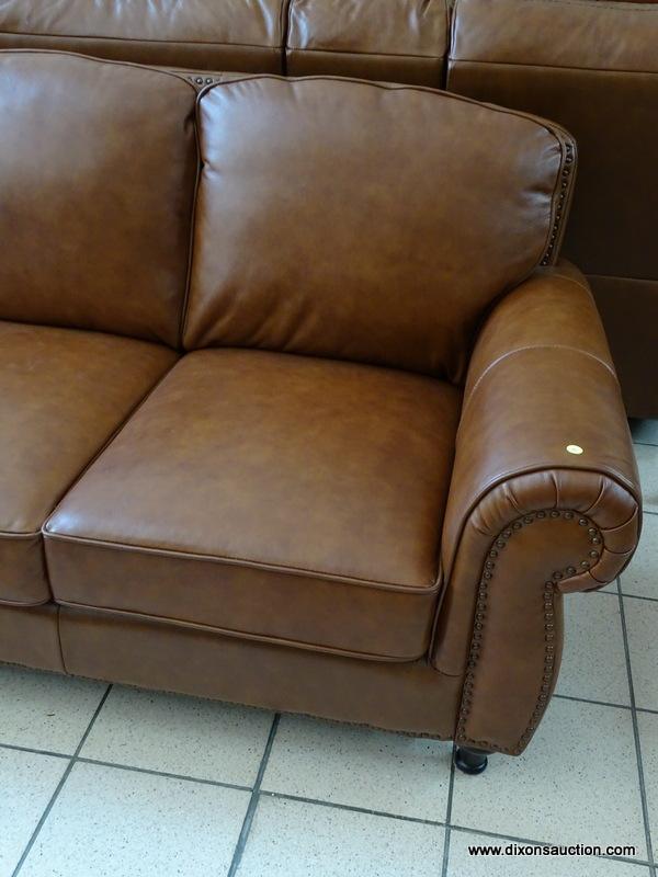 BRAND NEW ABBYSON TOP GRAIN LEATHER 3 CUSHION SOFA WITH BRASS STUDDED ACCENTS AND ROLLED ARMS.