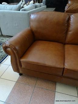 BRAND NEW ABBYSON TOP GRAIN LEATHER 3 CUSHION SOFA WITH BRASS STUDDED ACCENTS AND ROLLED ARMS.