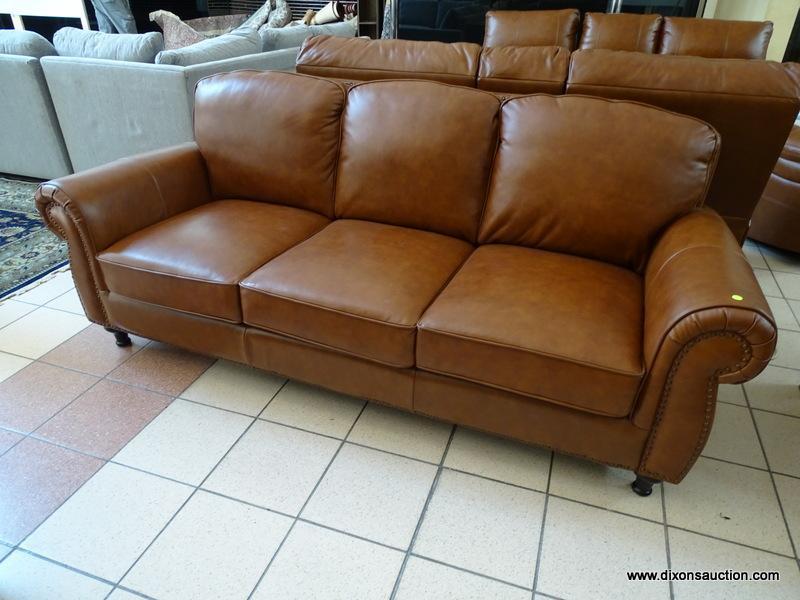 BRAND NEW ABBYSON TOP GRAIN LEATHER 3 CUSHION SOFA WITH BRASS STUDDED ACCENTS AND ROLLED ARMS.