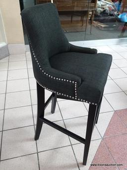 BRAND NEW GRAY UPHOLSTERED BAR CHAIR WITH SILVER TONE STUDDING AROUND THE EDGES. MEASURES 20 IN X 21