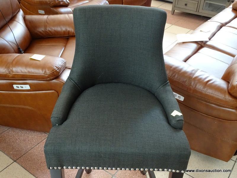 BRAND NEW GRAY UPHOLSTERED BAR CHAIR WITH SILVER TONE STUDDING AROUND THE EDGES. MEASURES 20 IN X 21