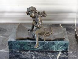 (FOYER) 2 FIGURAL ITEMS; MARBLE AND BRONZE CHERUB- 3.5 IN TALL WITH PLASTIC CASE AND A CLAY FIGURE