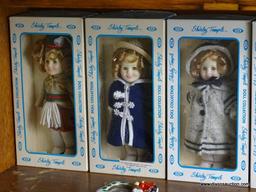 (UPBED 1) SHELF LOT 0F 6 SHIRLEY TEMPLE DOLLS IN ORIGINAL BOXES AND INCLUDES ANNIE DOLL IN BOX- 6 IN