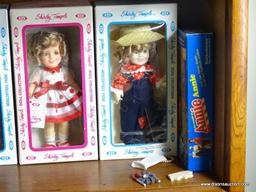 (UPBED 1) SHELF LOT 0F 6 SHIRLEY TEMPLE DOLLS IN ORIGINAL BOXES AND INCLUDES ANNIE DOLL IN BOX- 6 IN