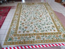 CHINESE SCULPTED AREA RUG IN IVORY, GREEN, AND FLORAL. MEASURES APPROXIMATELY 10 FT X 14 FT. ITEM IS