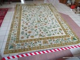 CHINESE SCULPTED AREA RUG IN IVORY, GREEN, AND FLORAL. MEASURES APPROXIMATELY 10 FT X 14 FT. ITEM IS