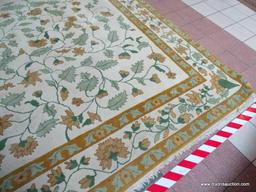 CHINESE SCULPTED AREA RUG IN IVORY, GREEN, AND FLORAL. MEASURES APPROXIMATELY 10 FT X 14 FT. ITEM IS