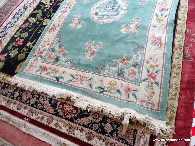 HANDMADE SCULPTED CHINESE RUG IN GREEN, IVORY, AND MAUVE WITH A DRAGON THEMED CENTER MEDALLION.