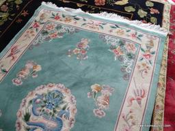 HANDMADE SCULPTED CHINESE RUG IN GREEN, IVORY, AND MAUVE WITH A DRAGON THEMED CENTER MEDALLION.