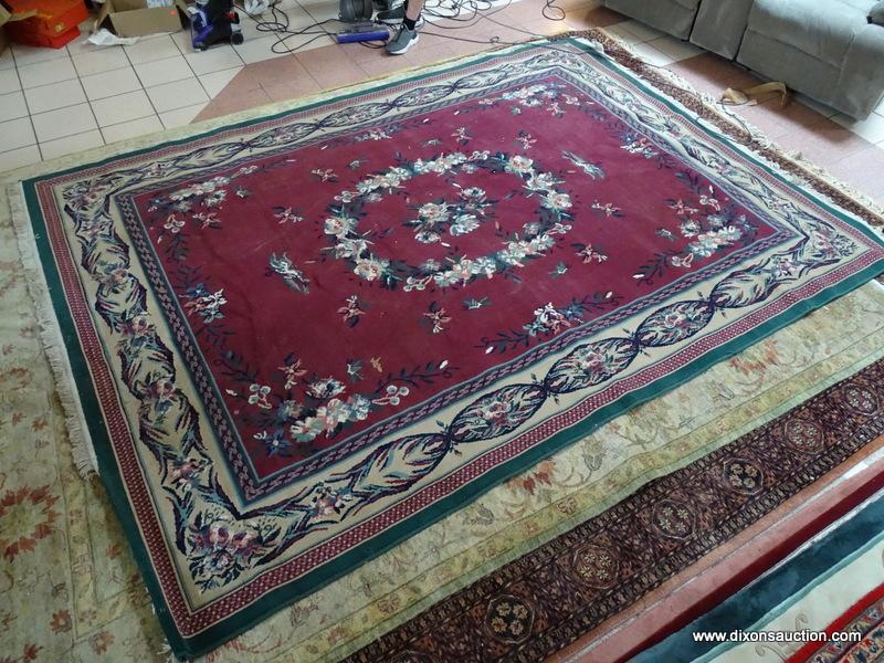 MACHINE MADE ORIENTAL STYLE RUG IN GREEN, IVORY, AND BURGUNDY. MEASURES APPROXIMATELY 7 FT 10 IN X