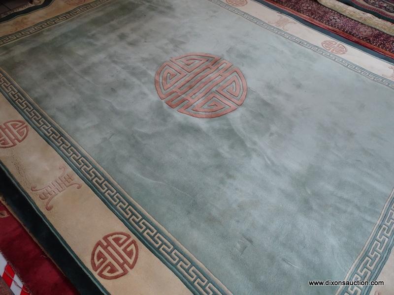 HANDMADE SCULPTED CHINESE RUG IN GREEN, IVORY AND BEIGE WITH CHINESE SCRIPT. MEASURES APPROXIMATELY