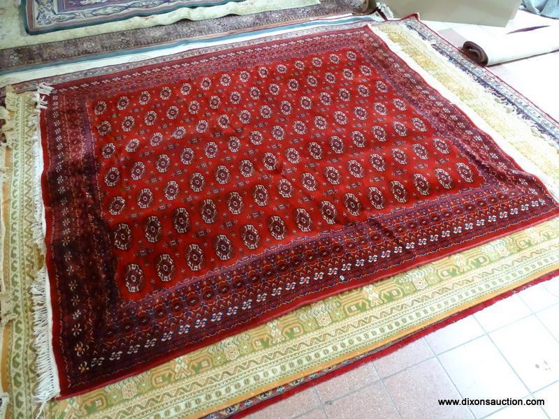 MACHINE MADE KARASTAN SILKY BOKHARA IN RED, IVORY AND BLUE. MEASURES APPROXIMATELY 8 FT X 10 FT.