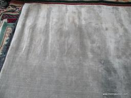 ESTATE OWNED HANDMADE GRAY AREA RUG. MADE IN INDIA. MEASURES APPROXIMATELY 6 FT 3 IN X 9 FT 9 IN.