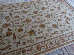 MACHINE MADE ORIENTAL STYLE AREA RUG IN BEIGE AND RUST. IN THE SPHINX PATTERN. MEASURES